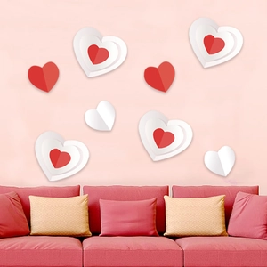 3D heart wall stickers in red and white on pink wall above a modern sofa decor