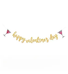Close-up of glitter gold Happy Valentine's Day banner with cocktail and red lip accents