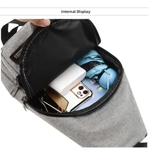Internal display of grey fabric sling bag showing storage space for phone and power bank