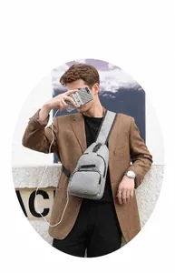 Detailed view of the men's grey chest bag showing a convenient external USB charging port