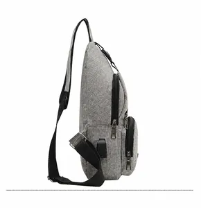 Side view of gray chest bag showing the built-in USB charging port and zipper layers