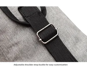 Detail of adjustable silver metal buckle and durable black strap on a grey fabric chest bag