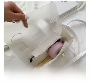 Internal view of transparent graffiti handbag showing zipper pocket and phone capacity