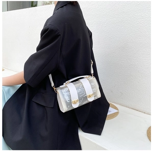 Close-up of a white translucent graffiti tote bag with gold rotary lock and leather straps