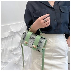 Detail of cylindrical jelly bag featuring black graffiti print and light green leather straps