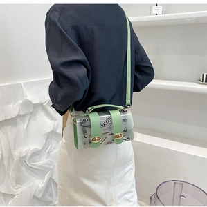Detailed shot of transparent PVC crossbody bag with mint green strap and star graffiti