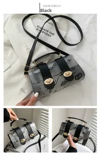 Detail of transparent black jelly bag with graffiti print and gold twist lock closure