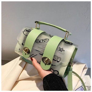 Close-up of light green translucent graffiti bucket bag with gold metal twist lock