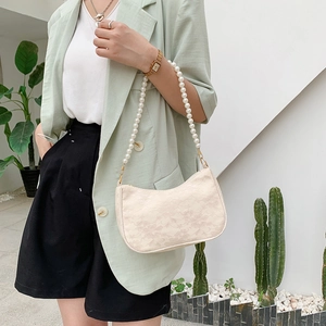 White lace baguette shoulder bag with pearl chain handle and minimalist pleated design