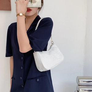 Elegant white ruched underarm bag with jacquard patterns and pearl chain strap