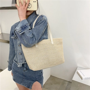 Large woven straw tote bag for women with white leather shoulder straps in beige color