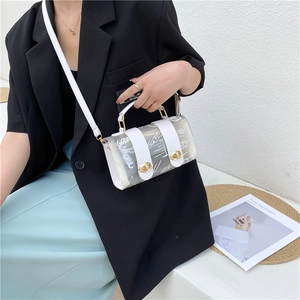 Transparent jelly handbag with white graffiti stars shown worn as a crossbody bag