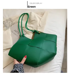 Detailed close-up of green leather woven tote bag with premium wide grid pattern texture