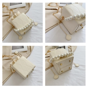 Detailed views of a beige bucket bag with pearl handle and golden chain strap details