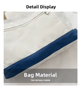 Detail shot of sturdy cream canvas fabric with blue contrast trim and metal zipper closure