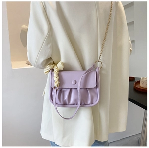 Detail of light purple pleated cloud bag with stylish silk scarf and gold chain strap