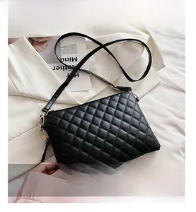 Detail showing the black quilted PU leather texture and gold-tone zipper of the crossbody bag