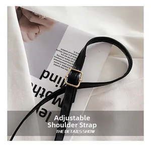 Detail of adjustable black PU leather shoulder strap with golden square metal buckle