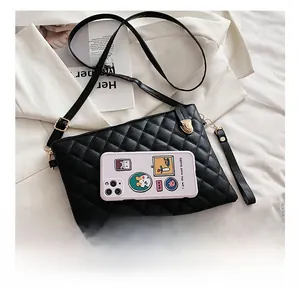 Detail showing the quilted black PU leather texture and golden metal buckle of the bag