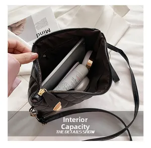 Detail view of the spacious interior of a black quilted bag showing storage capacity