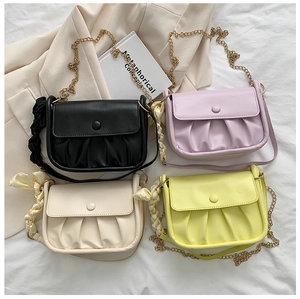 Collection of ruched cloud bags in black, purple, beige, and yellow with chain straps