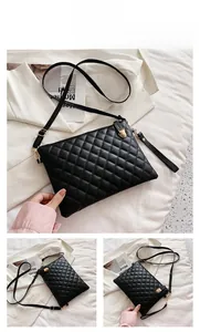 Detail view of black quilted PU leather crossbody bag with gold hardware and dual straps