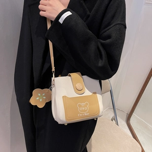 Minimalist beige and yellow bucket bag with cute bear print and floral pendant charm