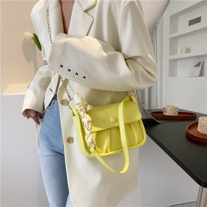 Minimalist bright yellow ruched cloud bag with woven handle and leather shoulder strap