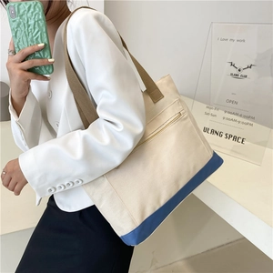 Minimalist canvas tote bag with blue base and zipper pocket for daily commute