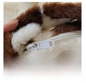 Close-up of smooth white zipper on plush faux fur bag with brown and white floral pattern