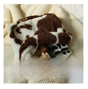 Detail view of the spacious inner compartment of the cow print plush tote bag