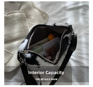 Macro shot showing internal capacity of the plush cow print bag with makeup items