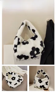 Detail of white plush shoulder bag with black floral patterns for autumn and winter