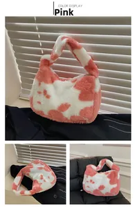 Detailed view of pink and white cow print faux fur tote bag with wide plush handles