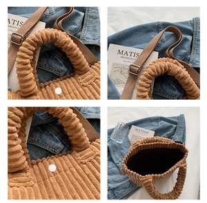 Detail view of brown corduroy bucket bag with magnetic closure and inner lining