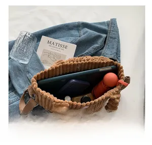 Spacious brown corduroy bucket bag interior showing capacity for tablet and essentials
