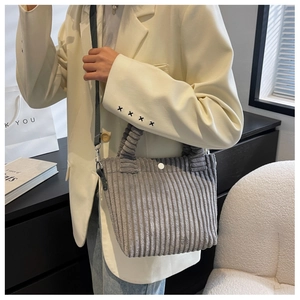 Detailed view of gray corduroy tote bag showing soft ribbed texture and adjustable strap