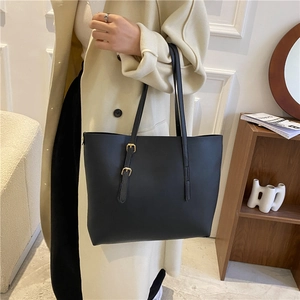 Minimalist black leather large tote bag with gold buckles for stylish daily commuting