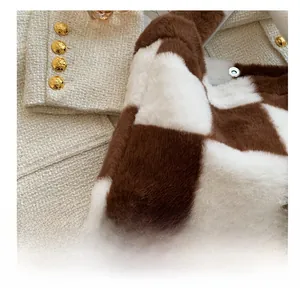 Detail of brown and white checkered plush bag with retro gold relief buckle texture