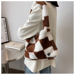 Detail of checkered faux fur shoulder bag in brown and white with plush texture