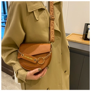 Details einer braunen Krokodil-Satteltasche mit Jacquard-Gurt und goldener Kette