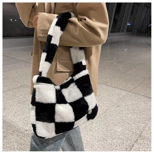 Detail of checkered plush tote bag showing the soft texture and black and white pattern
