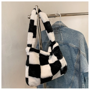 Detail shot of the plush black and white checkerboard tote bag with soft faux fur texture
