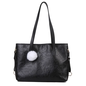 Large black leather tote bag with embossed cartoon patterns and white plush charm