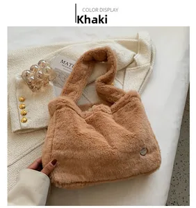 Detail of khaki plush handbag with soft faux fur texture and circular metal buckle