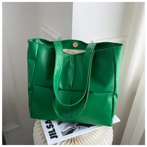 Detail of the large green quilted tote bag showing magnetic clasp and spacious interior