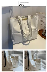 Close-up of white quilted tote bag with magnetic closure and elegant stitching detail