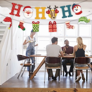 Christmas HO HO HO paper banner with Santa and reindeer hanging in a festive dining room