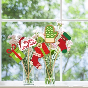 Christmas party photo props set with festive gloves and socks in flower vases