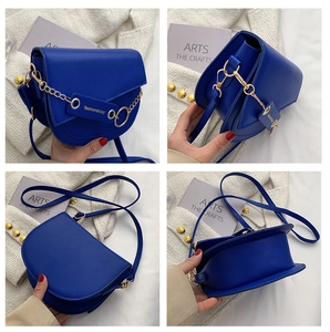 Detail views of Klein blue saddle bag with gold chain and adjustable strap